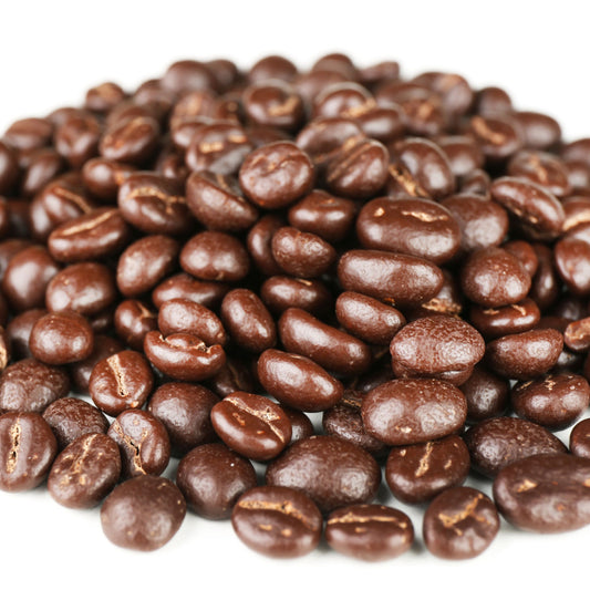 A close-up view of a pile of shiny, dark brown coffee beans, showcasing their smooth surfaces and slight variations in shape and size against a white background.