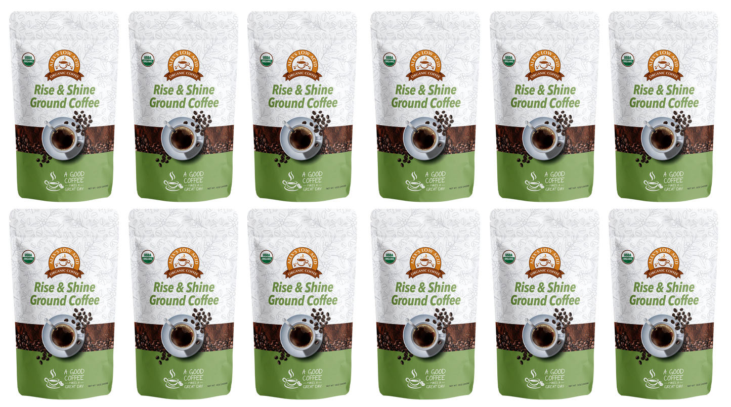 Twelve bags of Alex's Low-Acid Organic Coffee™ - Rise and Shine Fresh Ground (12oz) by Alex's Low Acid Coffee are arranged in three rows of four. The white and green packaging shows a coffee cup and beans, offering a low-acid option for heartburn relief.