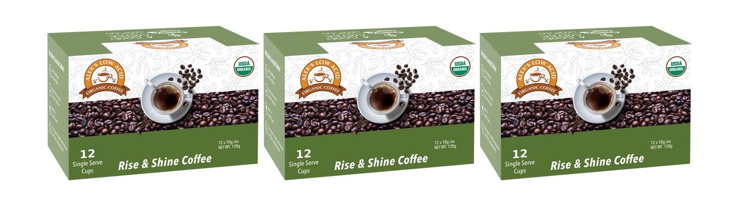 Three boxes of Alex's Low-Acid Organic Coffee™ K-Cups - Rise & Shine by Alex's Low Acid Coffee, each with coffee cup and bean art plus a green 12-cup label. Enjoy gentle, certified organic low-acid coffee for heartburn relief—seal on every box.