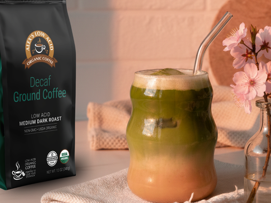 Bright green iced spring latte made with low acid coffee, matcha, and vanilla in a clear glass with ice.