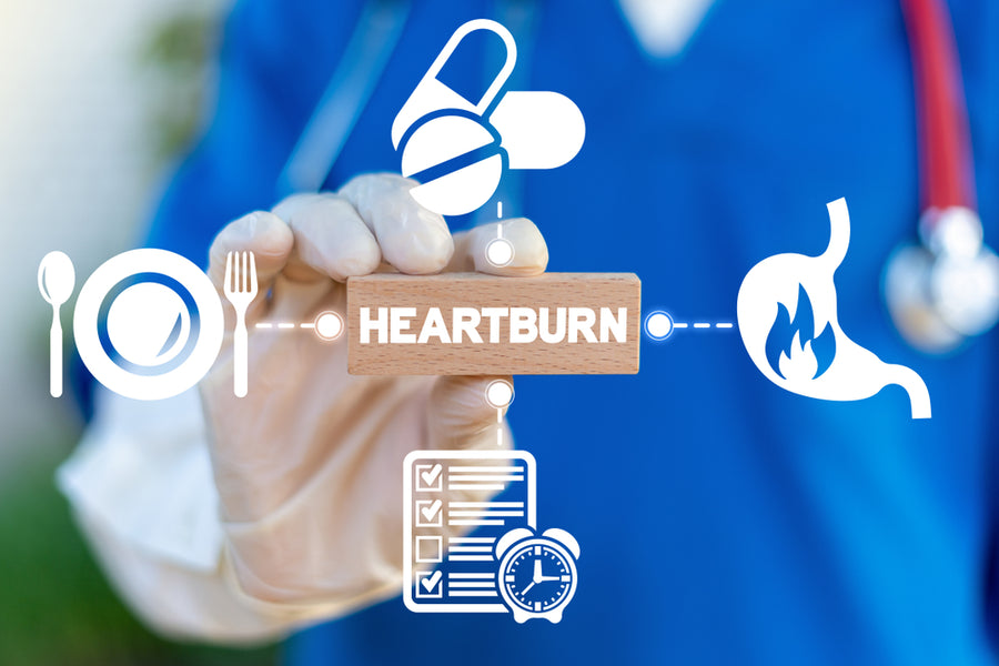 A healthcare professional in gloves holds a wooden block labeled "HEARTBURN," surrounded by icons representing food, medication, a checklist, and a stomach, indicating a focus on heartburn management.