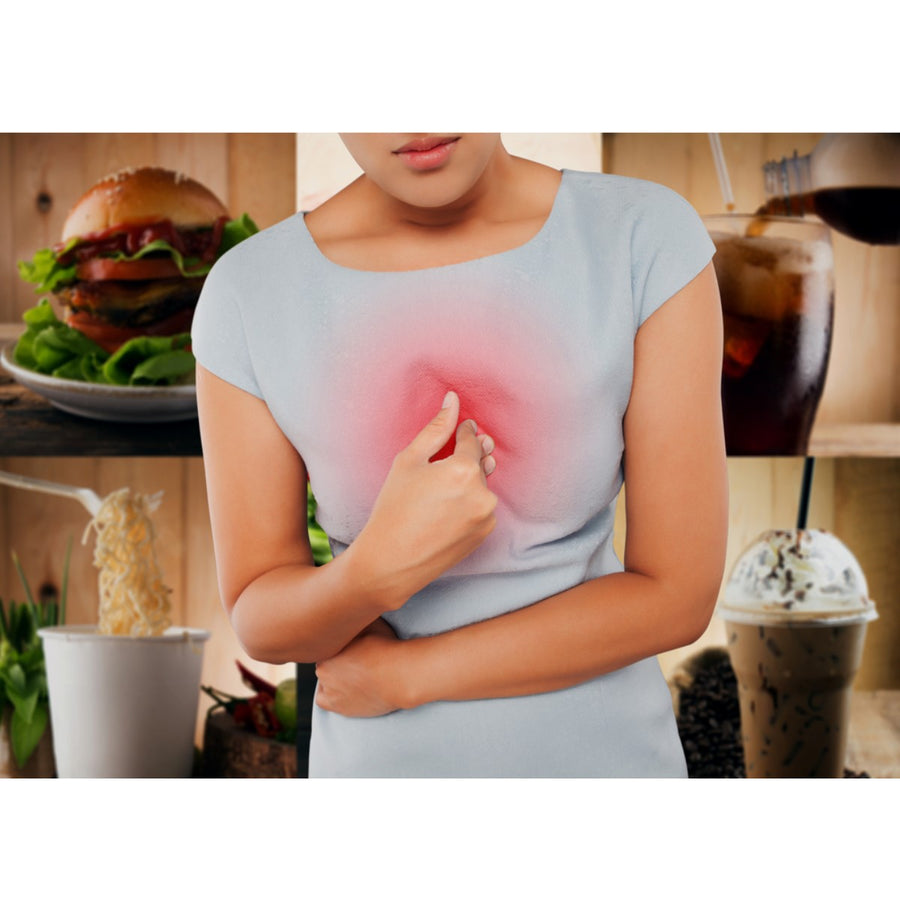 A woman in a light blue shirt holds her chest with a pained expression, surrounded by images of unhealthy foods like a burger, soft drinks, and ice cream, suggesting discomfort related to eating.