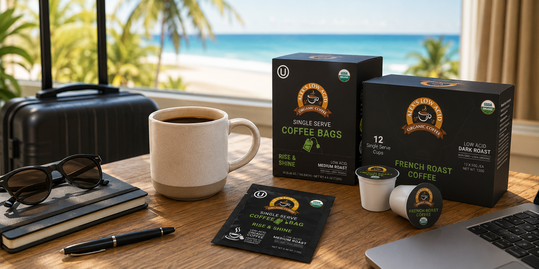 A coffee cup sits on a wooden table next to sunglasses, a notebook, and a pen, with travel bags in the background and a beach view, showcasing low-acid coffee products for travel convenience.