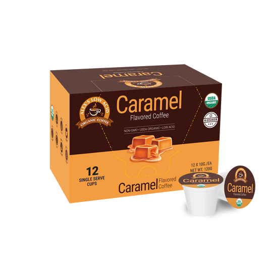 A box of Alex's Low Acid Organic Coffee™ Single Serve Flavored Cups - Caramel by Alex's Low Acid Coffee shows caramel imagery and certifications. The box contains 12 low acid pods, with one pod and its lid displayed in front.