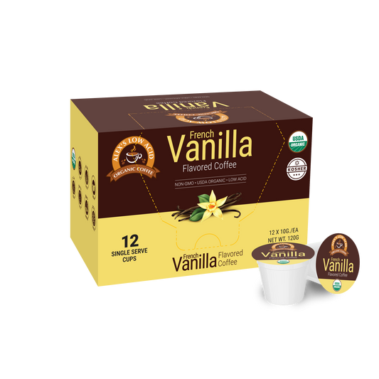 A yellow and brown box of Alex's Low Acid Organic Coffee™ Single Serve Flavored Cups - Vanilla (12 count) features “Organic Coffee,” certification logos, vanilla flower artwork, and a pod. This coffee is heartburn friendly and low in acid.
