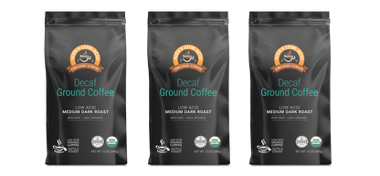 Three black bags of Alex's Low-Acid Organic Coffee™ - Decaf Fresh Ground (12oz) by Alex's Low Acid Coffee are displayed side by side on a white background—ideal low-acid coffee for heartburn relief.
