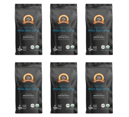 Six bags of Alex's Low-Acid Organic Coffee™ - Half Caff Whole Bean (12oz) by Alex's Low Acid Coffee, Medium Roast, are arranged in two rows of three on a white background. Each bag features low acid and organic certifications.