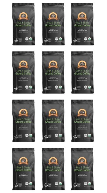 Twelve identical bags of Alex's Low-Acid Organic Coffee™ - Rise and Shine Fresh Ground (12oz) by Alex's Low Acid Coffee are arranged in four rows. Each black bag features an orange logo, white text, and USDA Organic and Fair Trade Certified symbols.