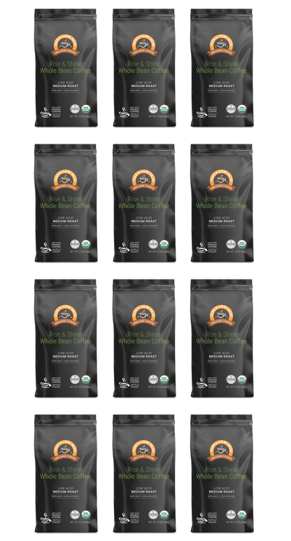 Twelve identical bags of Alex's Low-Acid Organic Coffee™ - Rise and Shine Whole Bean (12oz) by Alex's Low Acid Coffee are arranged in a 4x3 grid on a light background, each black bag displaying a brown and white label with certification icons below.