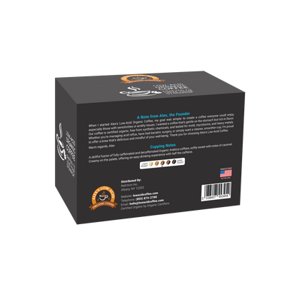 A black box of Alex's Low-Acid Organic Coffee™ Single Serve Cups - Half Caff by Alex's Low Acid Coffee, with a coffee cup logo, U.S. flag, low acid icons, brand story, tasting notes (sweetness, acidity, body), and certification details.
