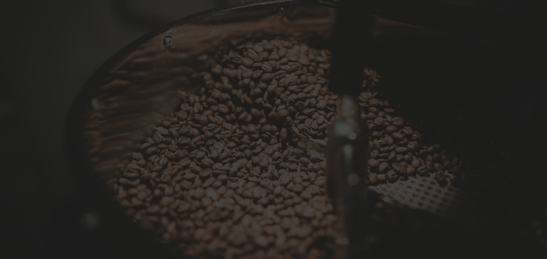Close-up of a coffee filter with coffee beans on a dark background