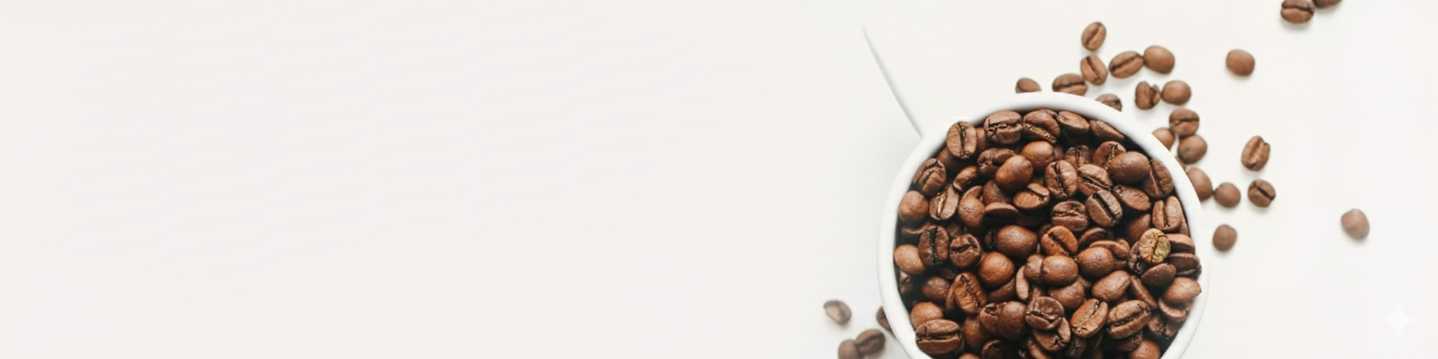 Coffee beans in a white cup on a light beige background