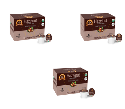 Three boxes of Alex's Low Acid Organic Coffee™ Hazelnut Single Serve Flavored Cups (12 per box) from Alex's Low-Acid Organic Coffee are arranged in a triangle on a white background, with heartburn-friendly pods displayed in front.