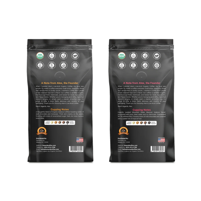 Two black Alex's Low-Acid Organic Coffee™ Whole Bean Variety Pack (12oz) bags stand side by side, backs visible. Each features certification icons, a founder’s note, cupping notes with flavor icons, and a U.S. flag in the bottom right corner.